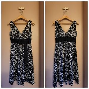 Black & white sleeveless floral dress with attached sash and bow. Size 4